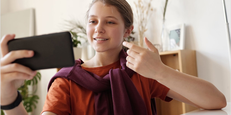 Image shows a girl using a mobile phone, may be for a consultation